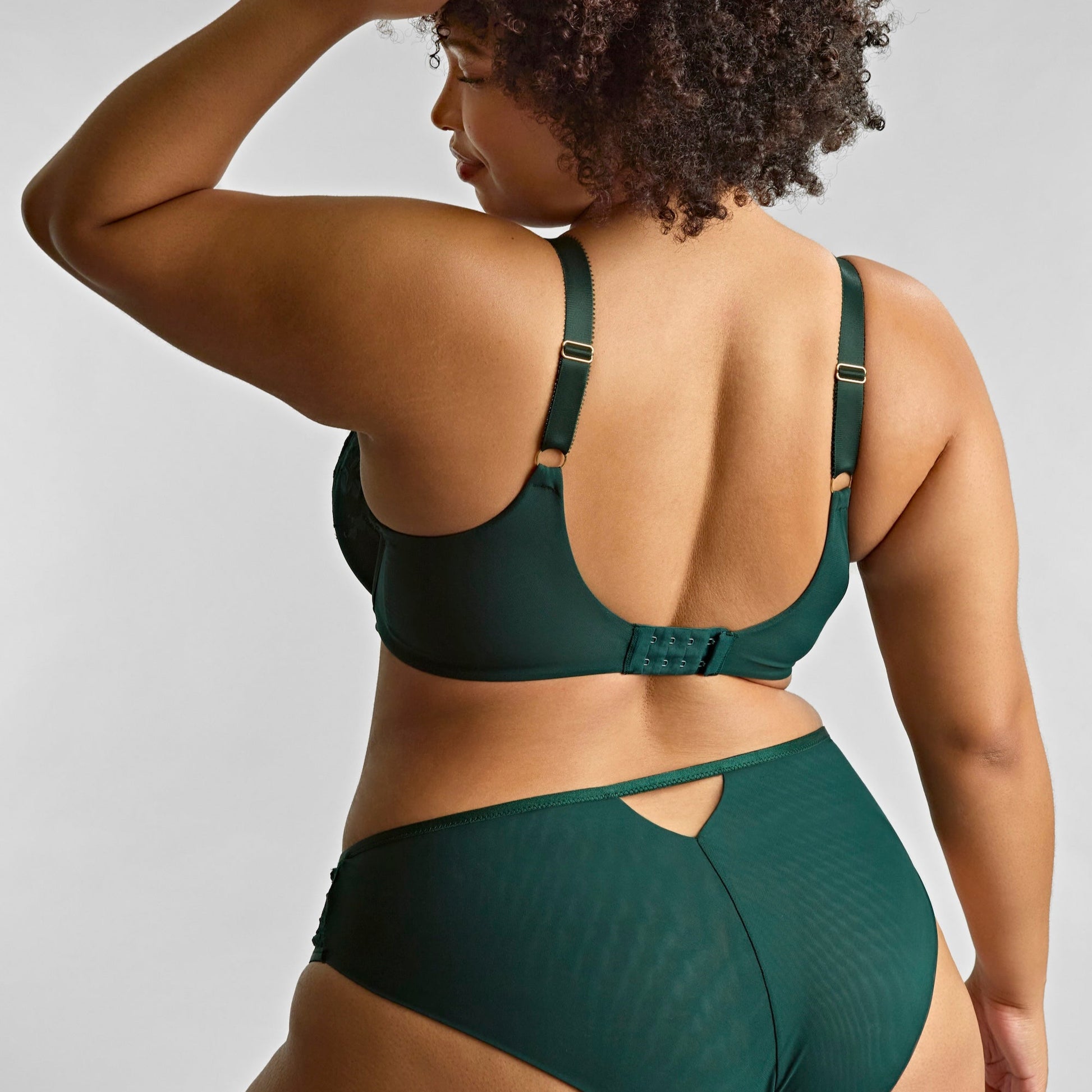 Person wearing a green bikini set against a plain background