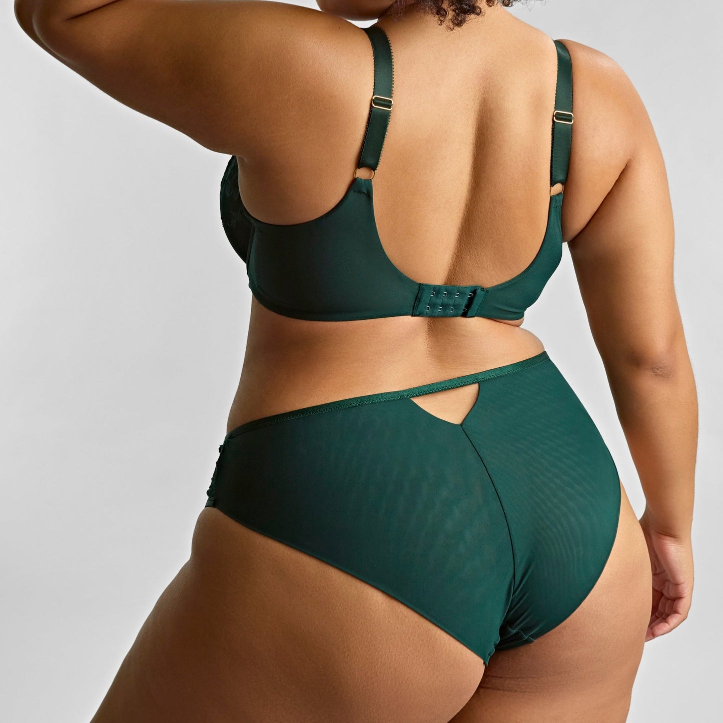Person wearing a green bikini set against a plain background