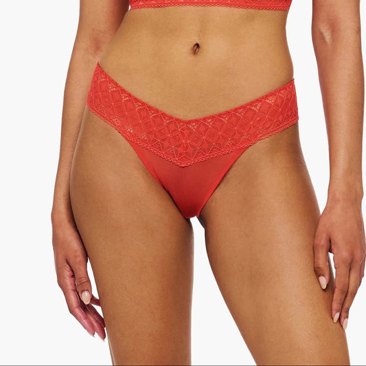 Woman wearing a red lace lingerie set on a white background