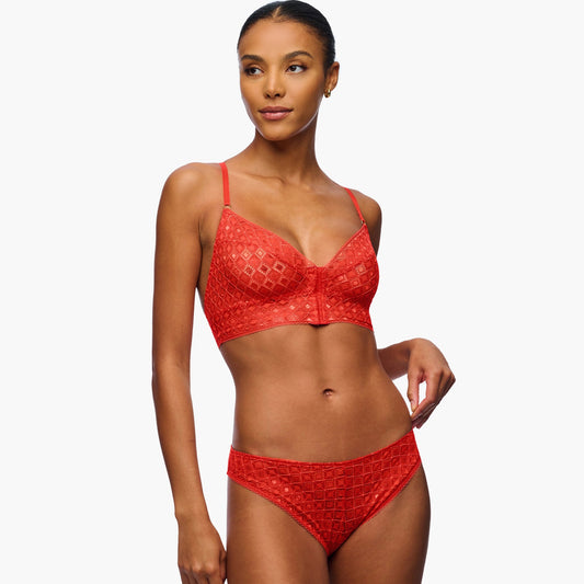 Woman wearing a red bikini set on a white background