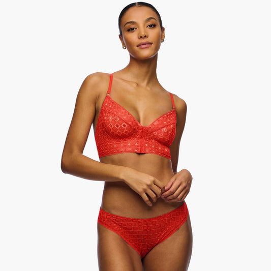 Woman wearing a red bikini set on a white background