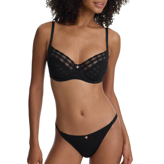 Woman wearing a black bikini set on a white background