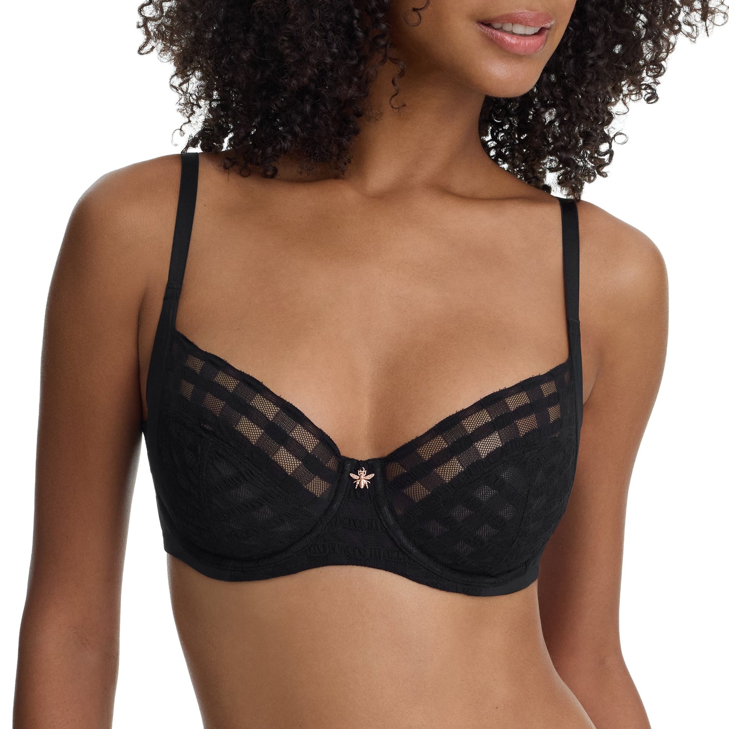 Black bra with mesh details worn by a model on a white background