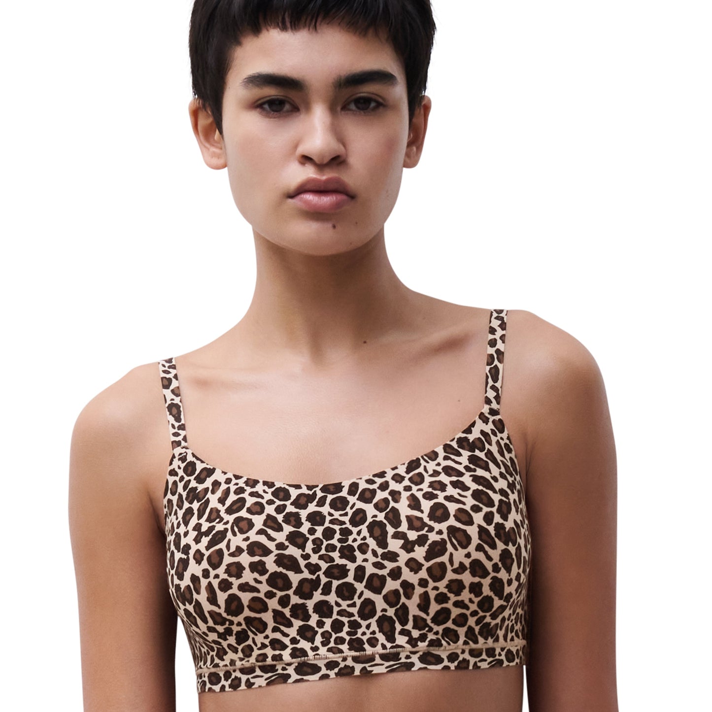 Model wearing a leopard print bikini top against a white background