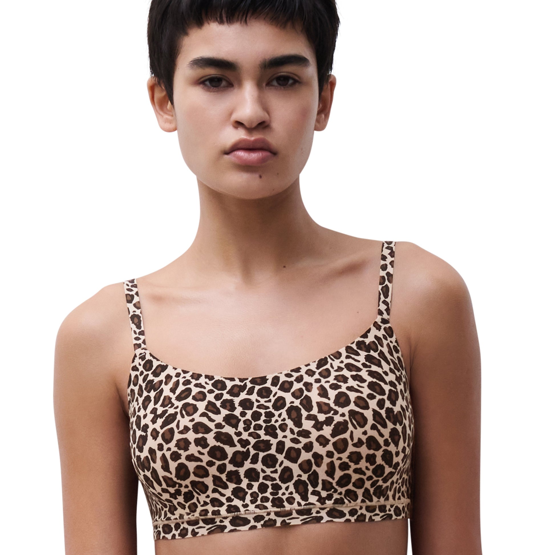 Model wearing a leopard print bikini top against a white background