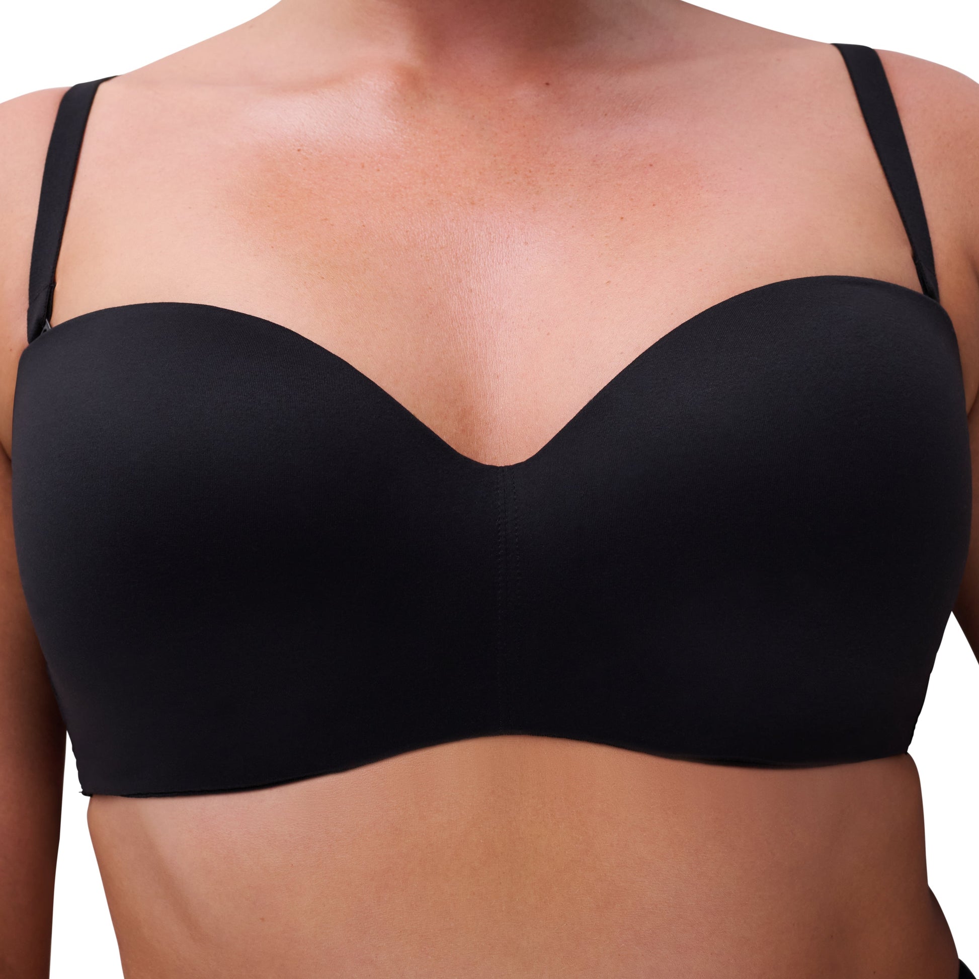 Black bra worn by a person on a white background