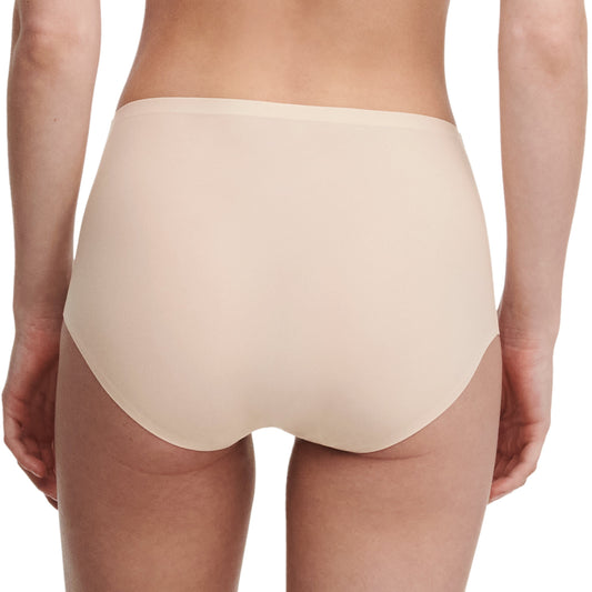 Beige underwear worn by a person on a white background