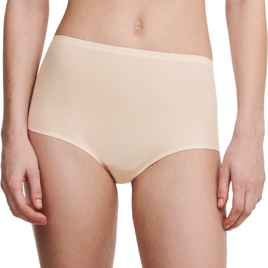 Beige underwear worn by a person on a white background