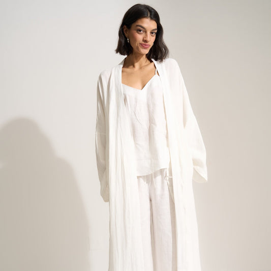 Woman wearing a white outfit against a plain background