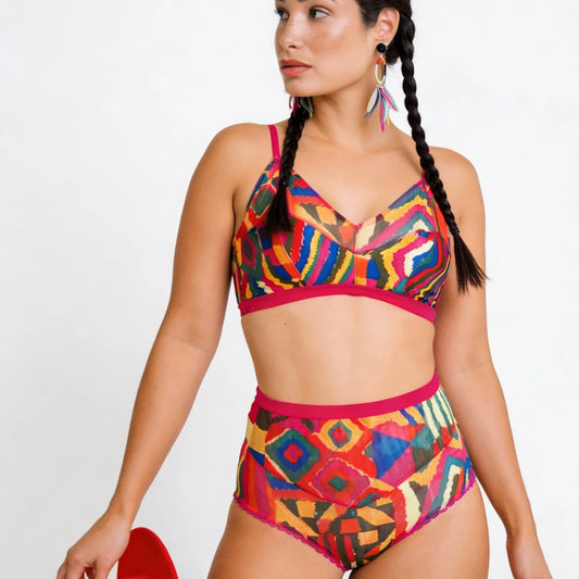 Woman wearing a colorful bikini with a geometric pattern on a white background