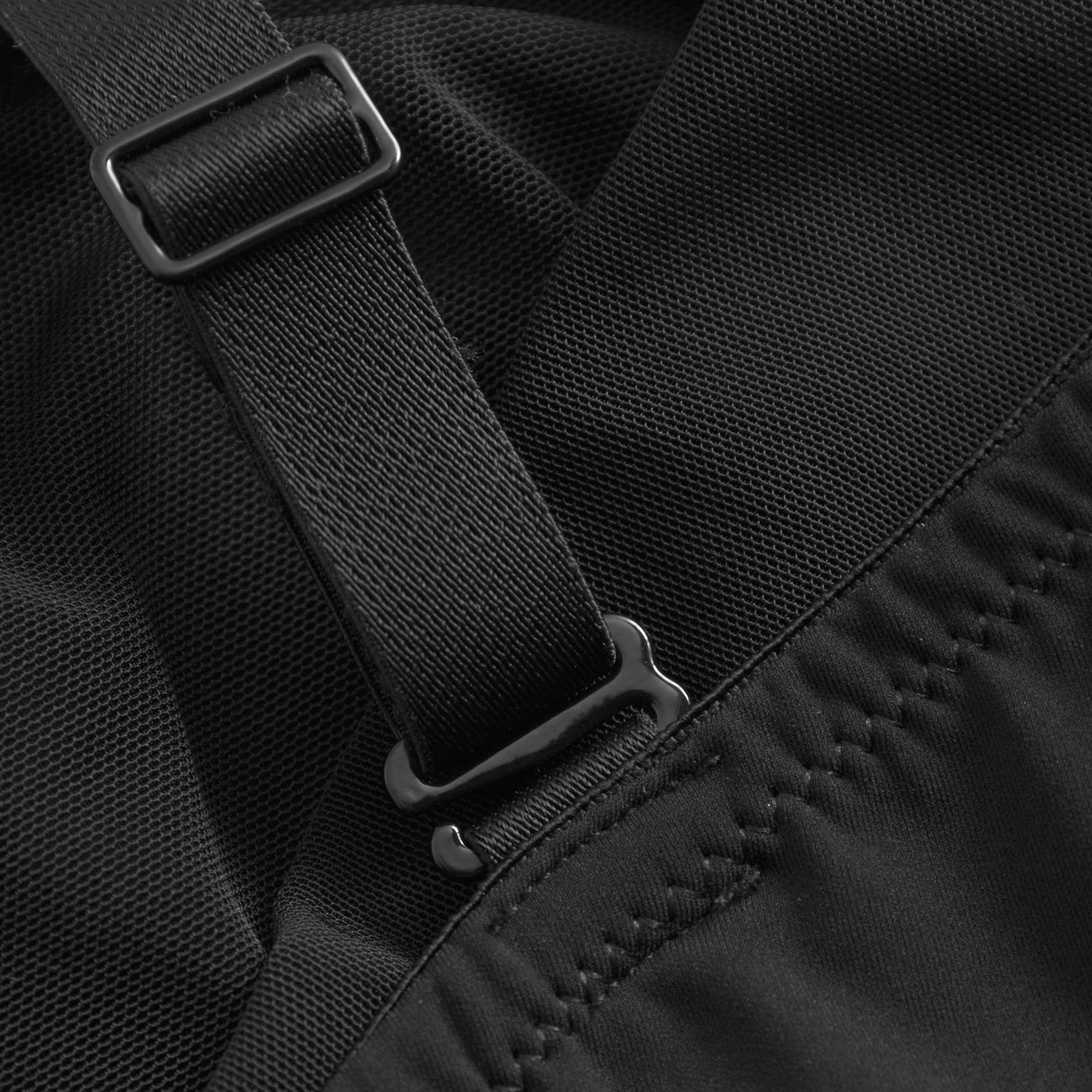Close-up of black fabric with a strap and buckle