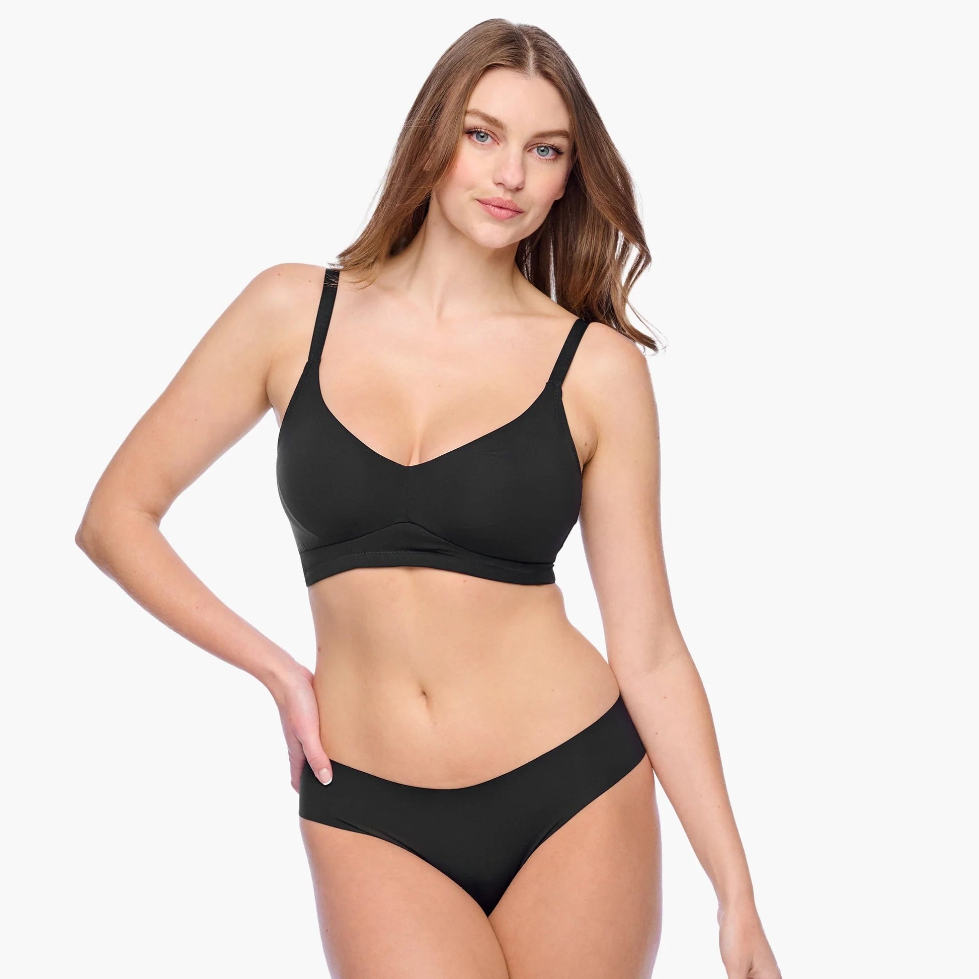 Woman wearing a black bralette on a white background