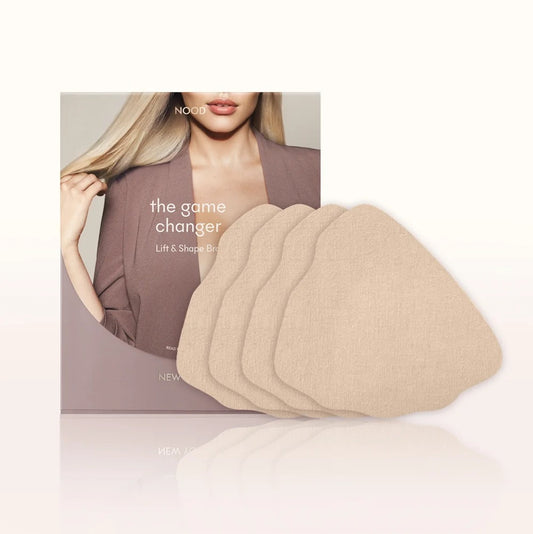Six beige fabric lift and shape pads fanned out in front of their product packaging box, which features a blonde model wearing a mauve blazer. The brand name 'NOUO' is visible on the box.