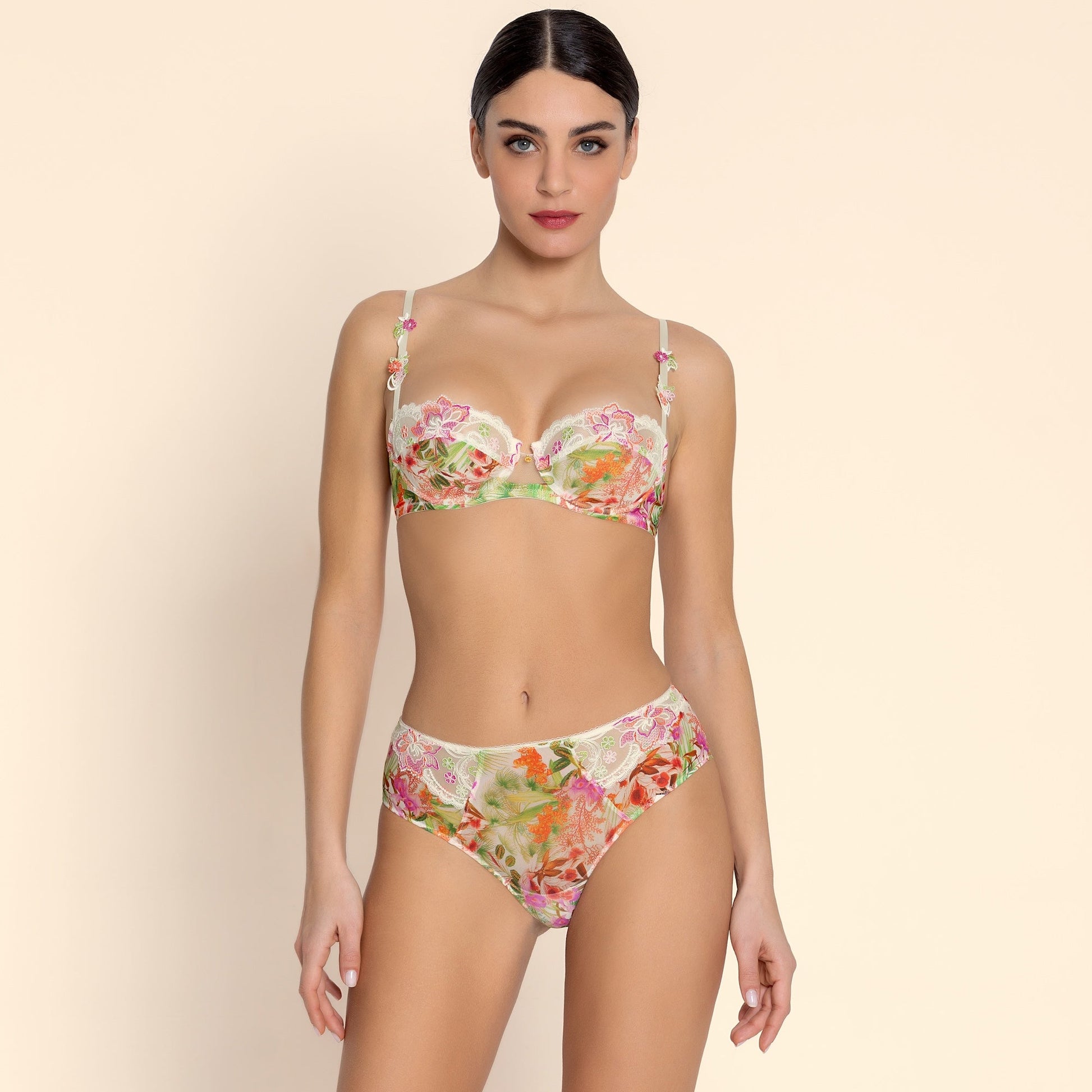 Woman wearing a floral bikini set on a beige background