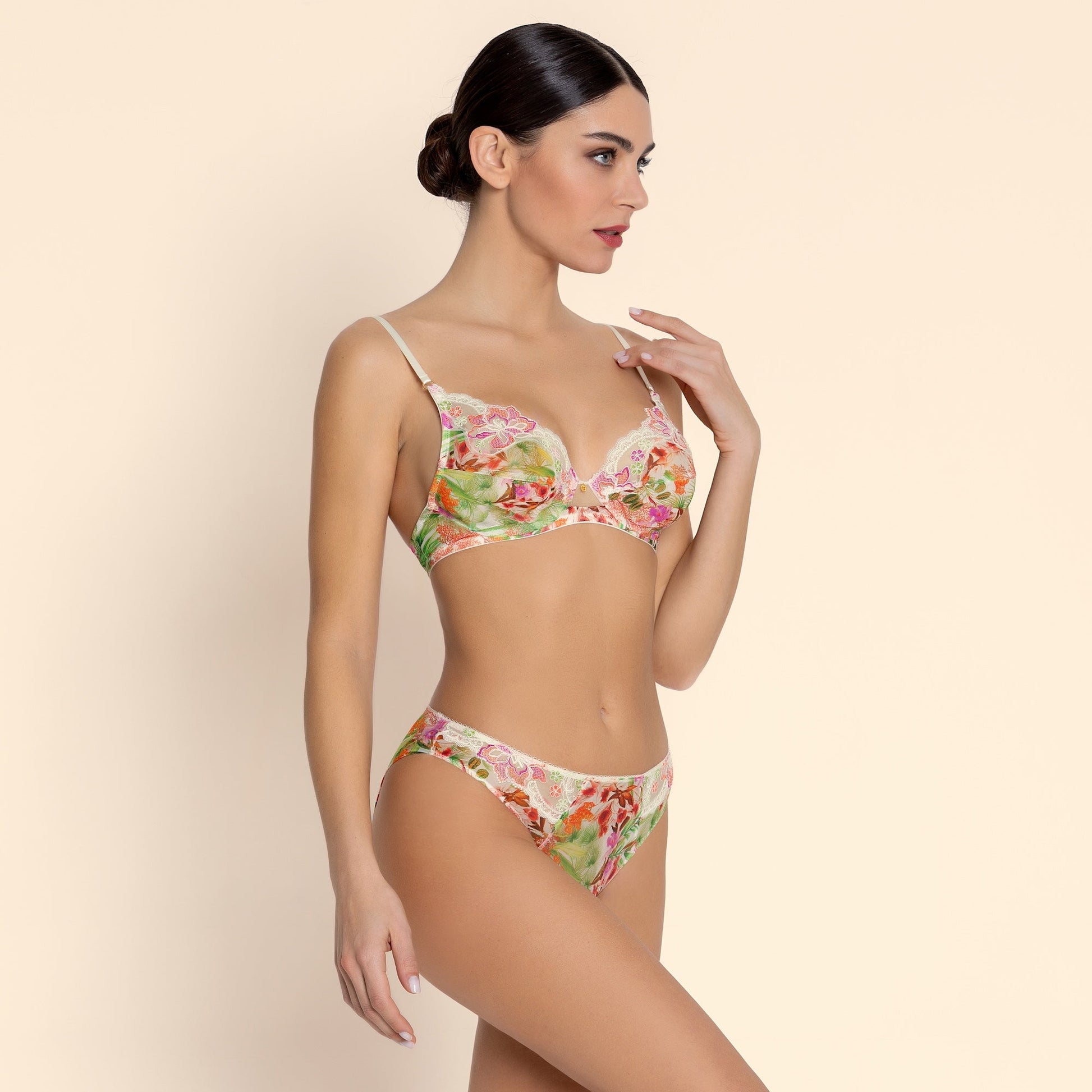 Woman wearing a floral lingerie set on a beige background