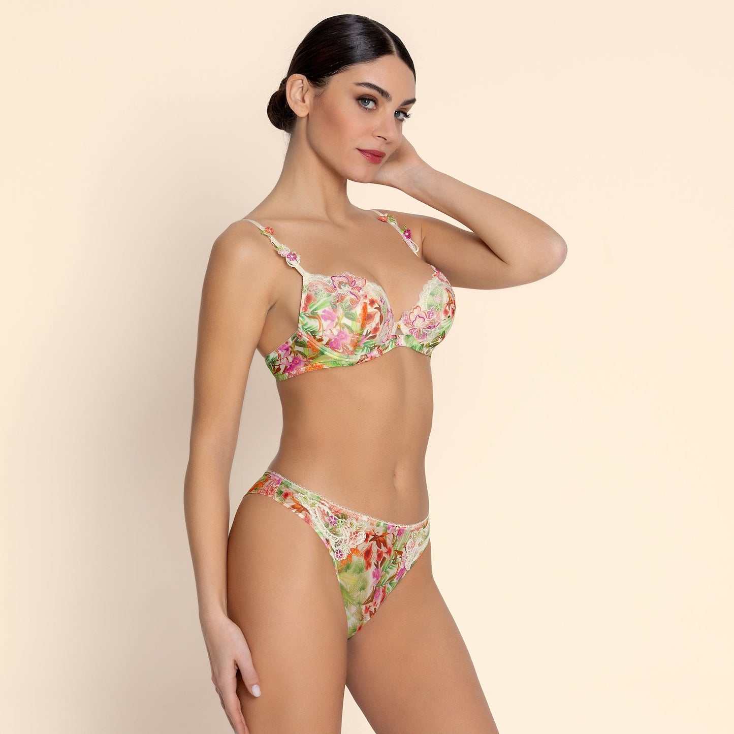 Woman wearing a floral lingerie set on a beige background