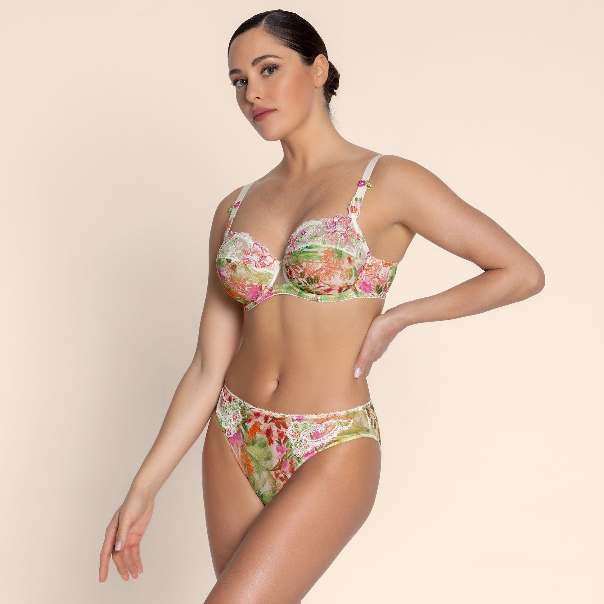 Woman wearing a floral bikini set on a beige background