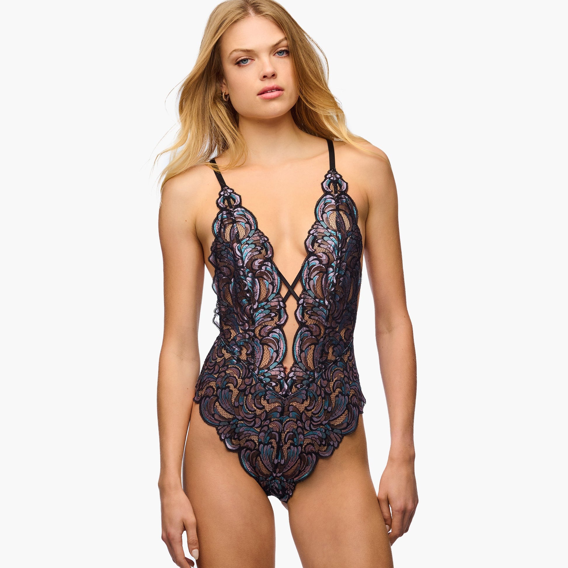 Woman wearing a black lace lingerie set on a white background