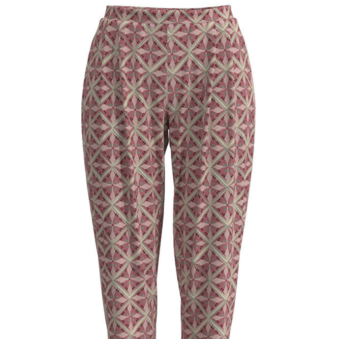 A pair of cropped trousers featuring a geometric, repeating starburst pattern in dusty rose pink and beige, shown against a plain white background.