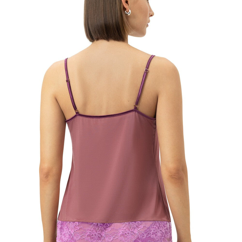A woman shown from the back wearing a mauve satin camisole with thin straps and matching purple lace panties against a plain white background.