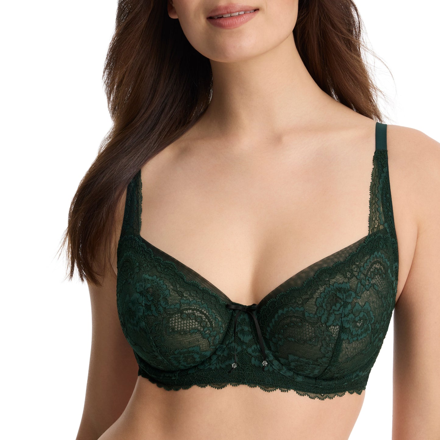 A woman wearing a dark forest green lace bra with scalloped edges and a small center bow, shown from the chest to the hips against a plain white background.