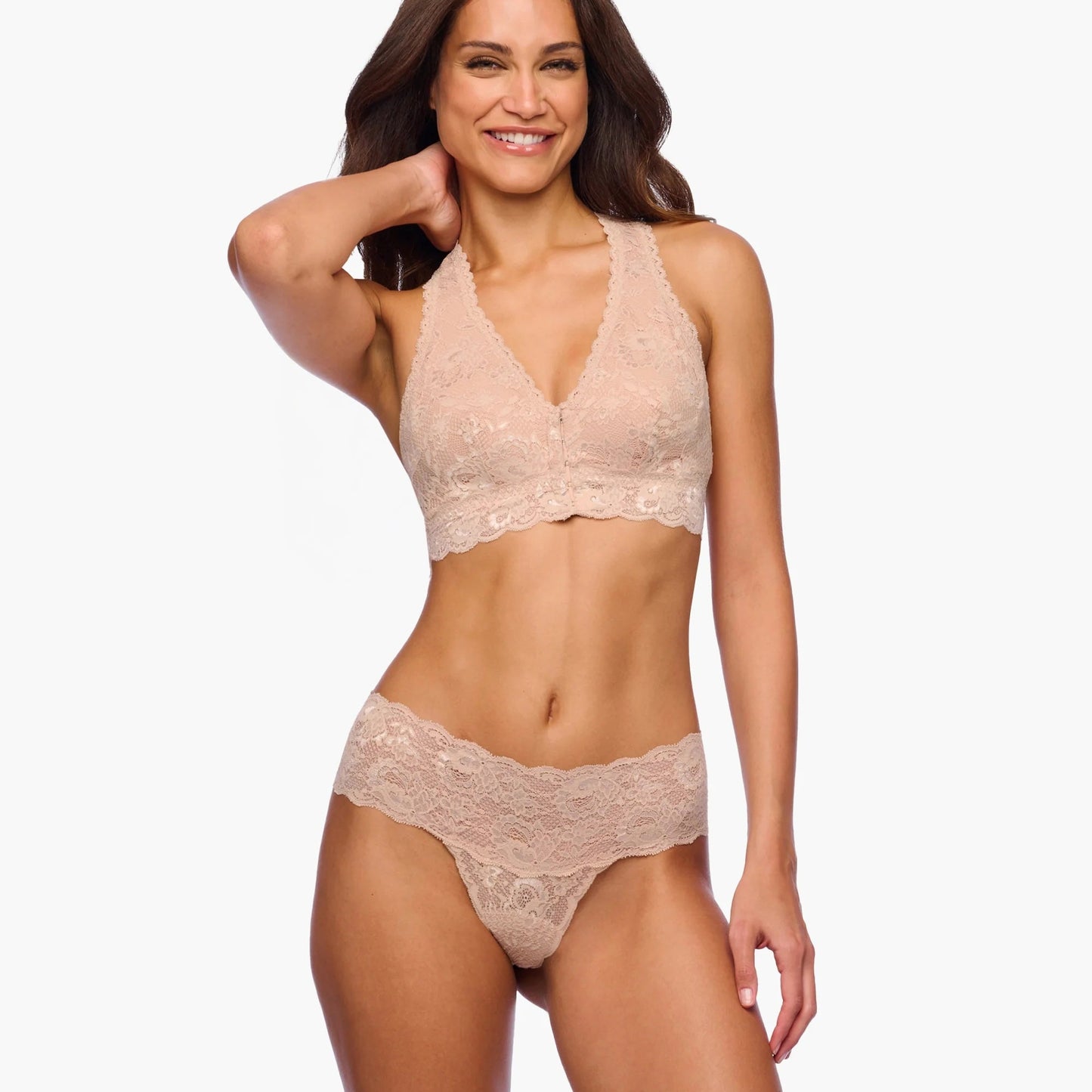 Woman wearing a beige lace lingerie set on a white background