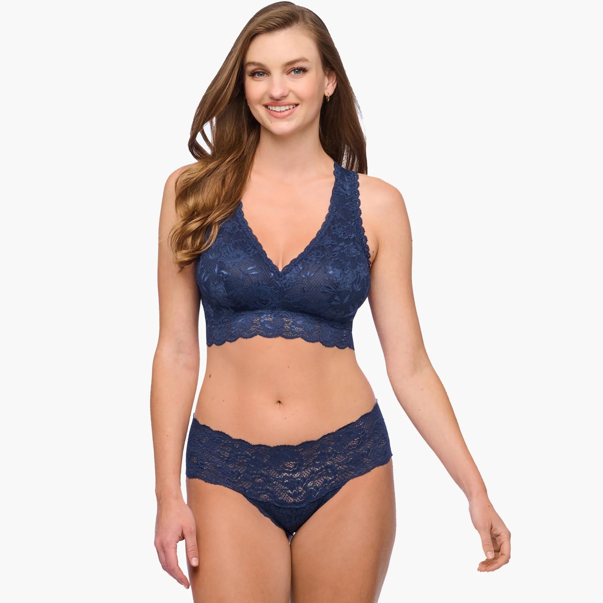 Woman wearing a navy blue lace lingerie set on a white background