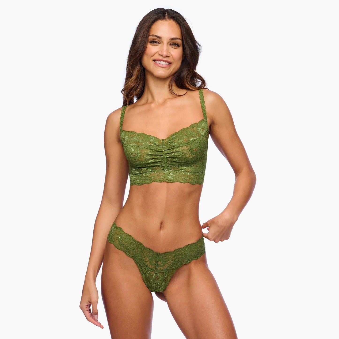 Woman wearing a green lace lingerie set on a white background