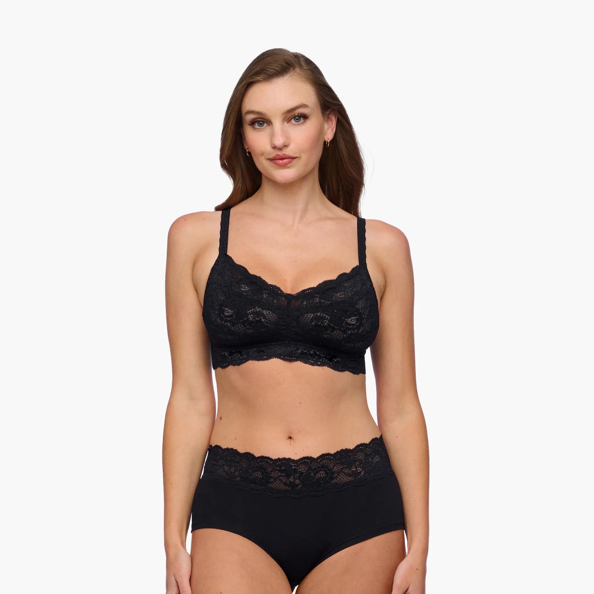 Woman wearing a black lace lingerie set on a white background