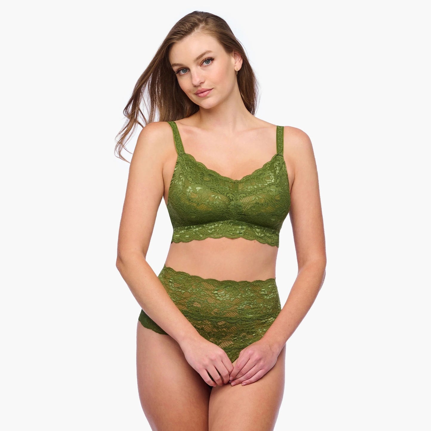 Woman wearing a green lace lingerie set on a white background