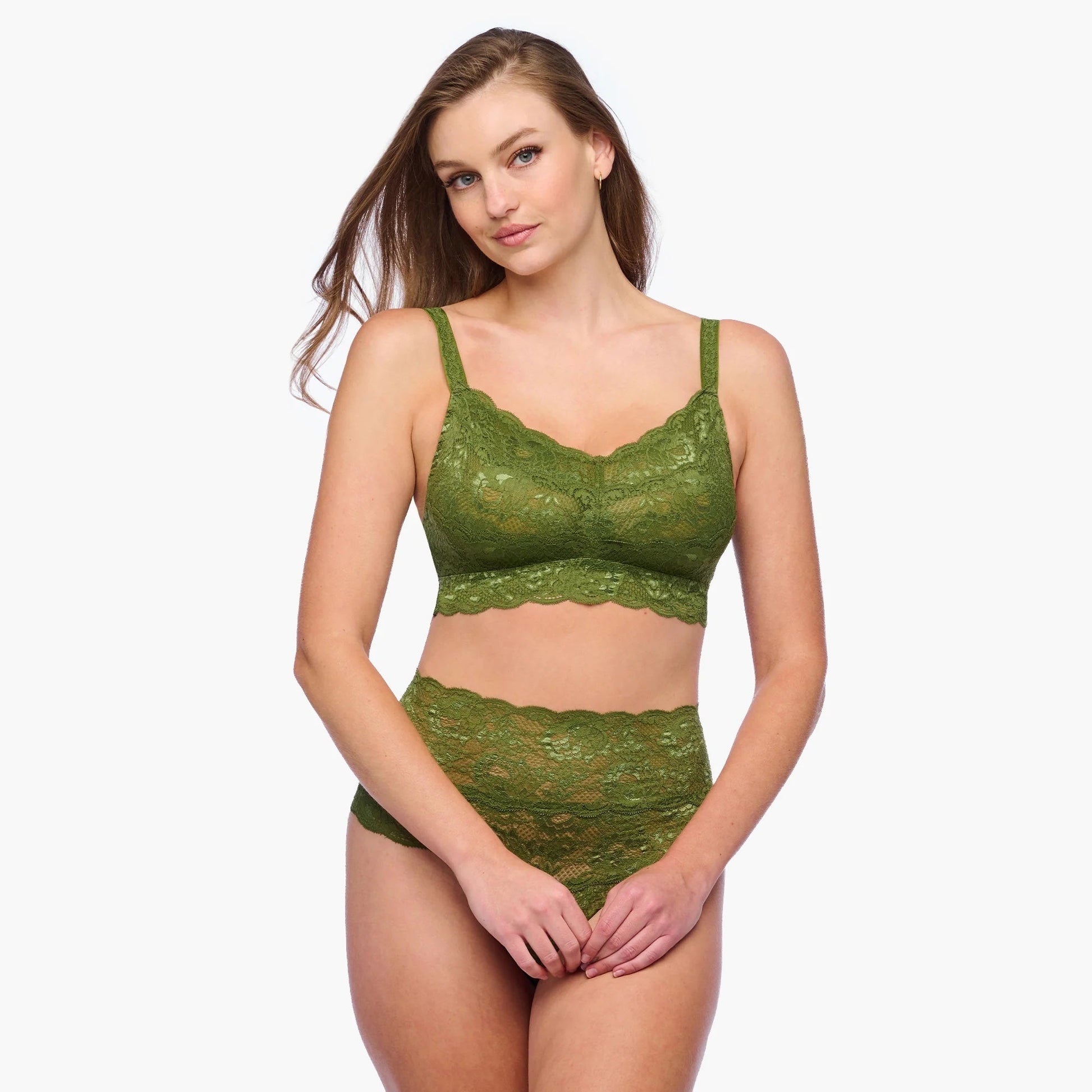 Woman wearing a green lace lingerie set on a white background