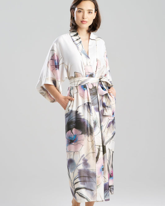 Woman wearing a floral kimono-style dress on a gray background