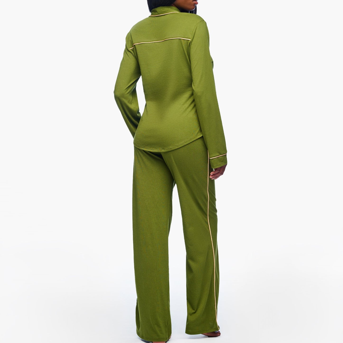 Woman wearing a green suit on a white background
