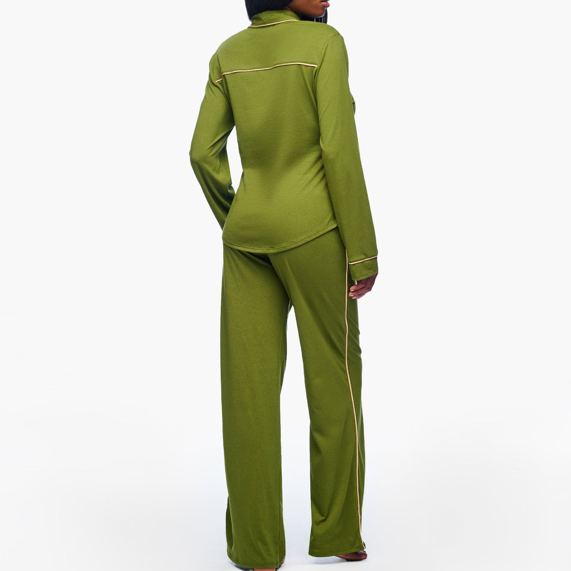 Woman wearing a green suit on a white background