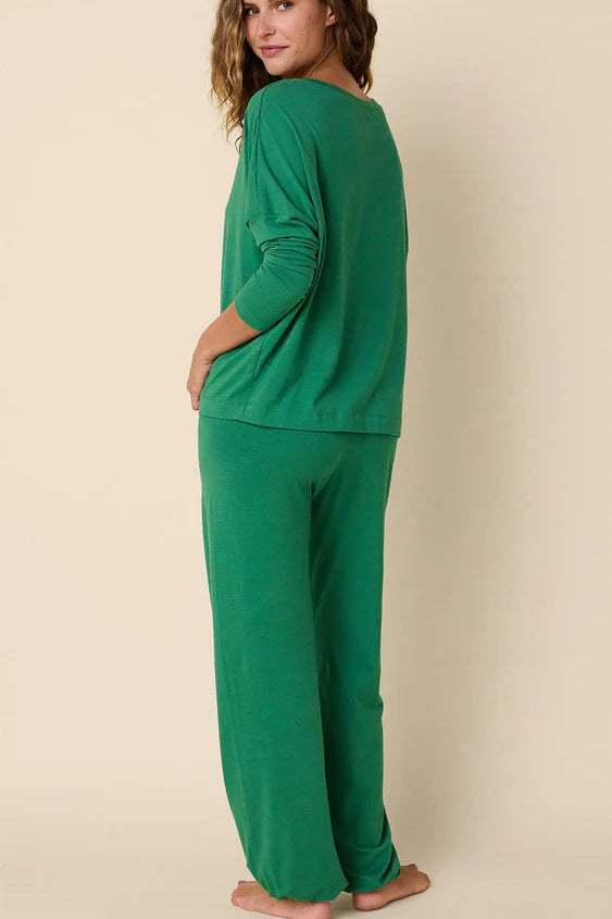 Woman wearing a green outfit on a beige background