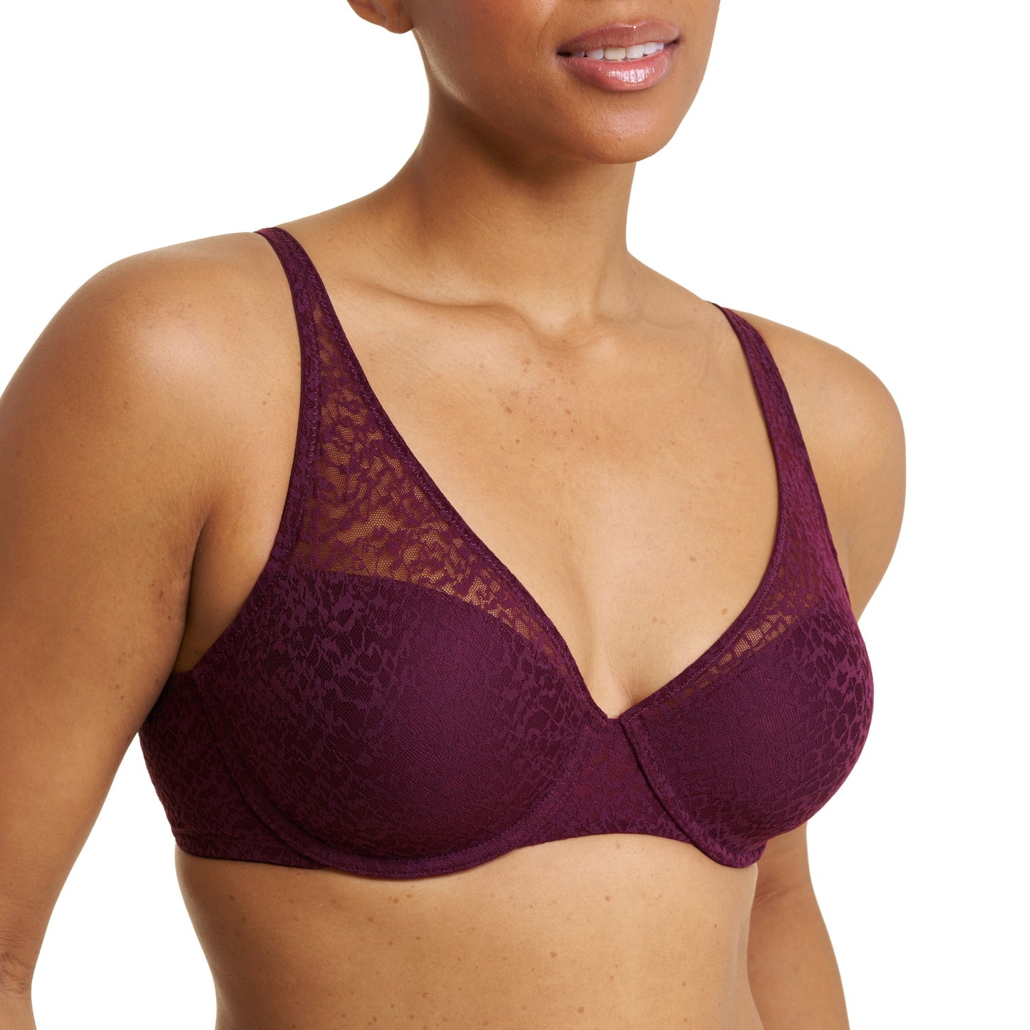 A close-up of a woman wearing a deep burgundy lace bra with smooth underband cups, shown against a plain white background.