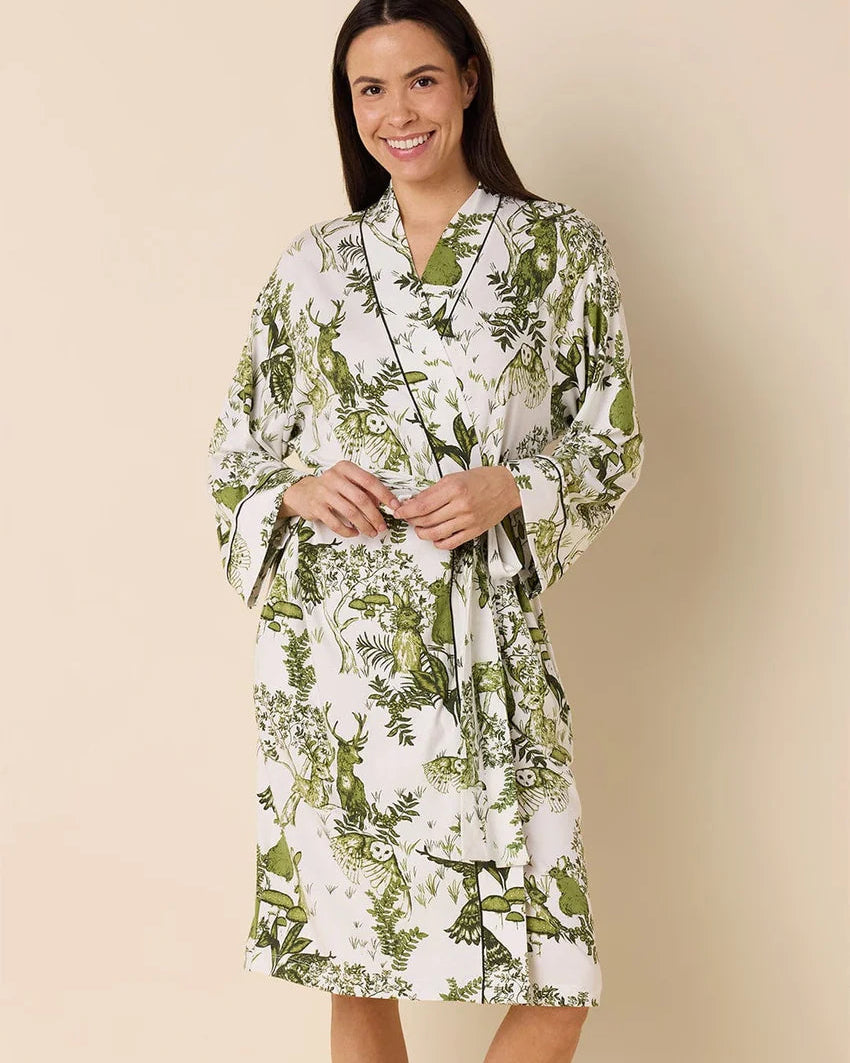 Woman wearing a floral robe against a beige background
