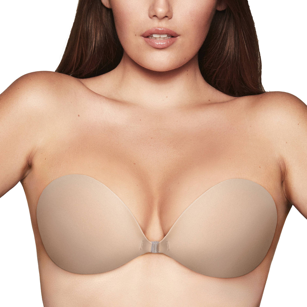 Woman wearing a beige strapless bra on a white background