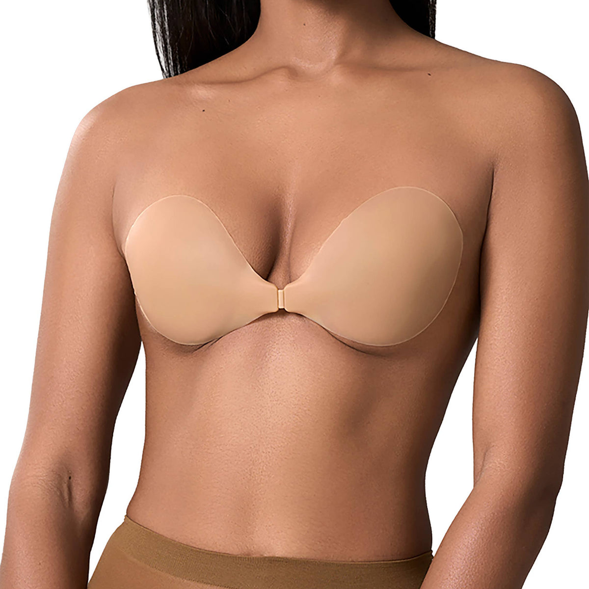 Woman wearing a beige strapless bra and underwear set on a white background